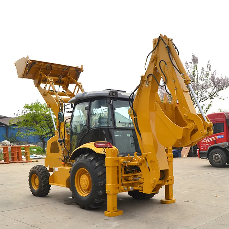 Yellow backhoe loader with loader bucket raised and backhoe arm extended on stabiliser legs, in the yard