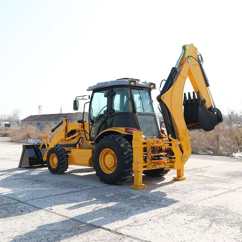 Yellow backhoe loader with front loader bucket lowered and backhoe arm raised, in the factory yard