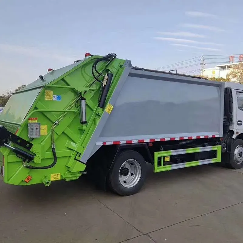 Side profile of a rear-loader garbage compactor truck with green compaction body and grey refuse bin