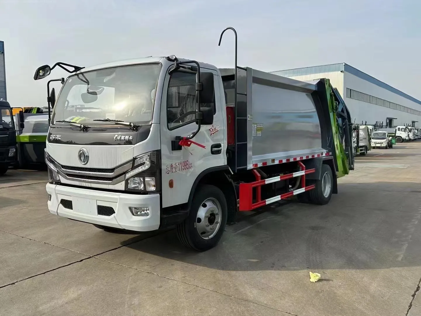 Dongfeng chassis rear-loader garbage truck, front three-quarter view showing the compactor body